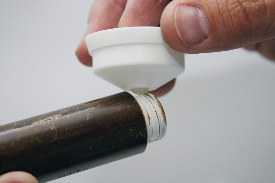 Lubricant being applied to PTFE Thread Sealing Cord from the bottom of the container